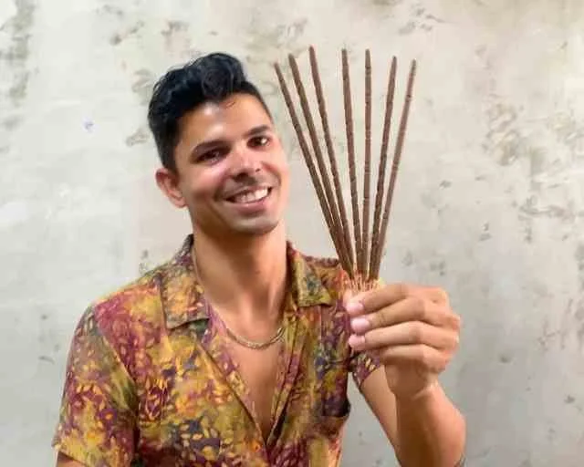 Guest holding a bundle of handmade incense sticks
