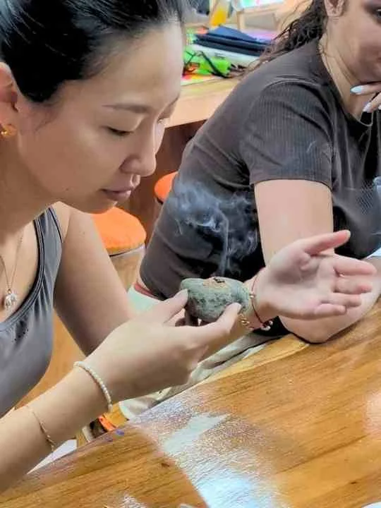 Guest holding incense for a smoke test